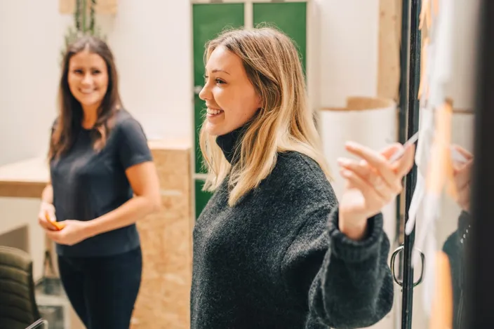 Young woman presenting in the meeting smiling