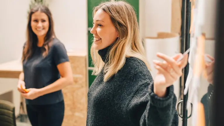 Young woman presenting in the meeting smiling