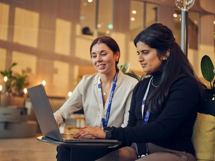 Two employees (women) working with laptop together