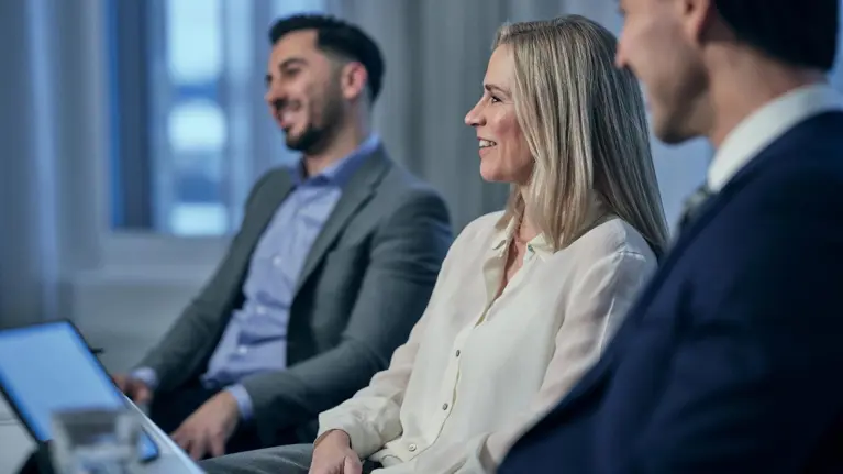 People in a meeting working together smiling