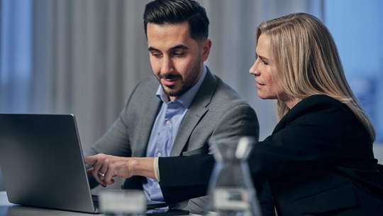 Man and woman working on laptop together