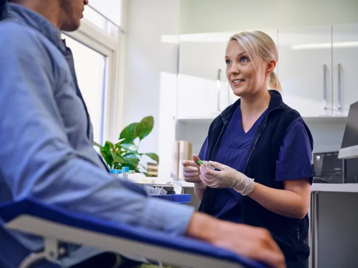 Medical worker taking blood sample in a lab 