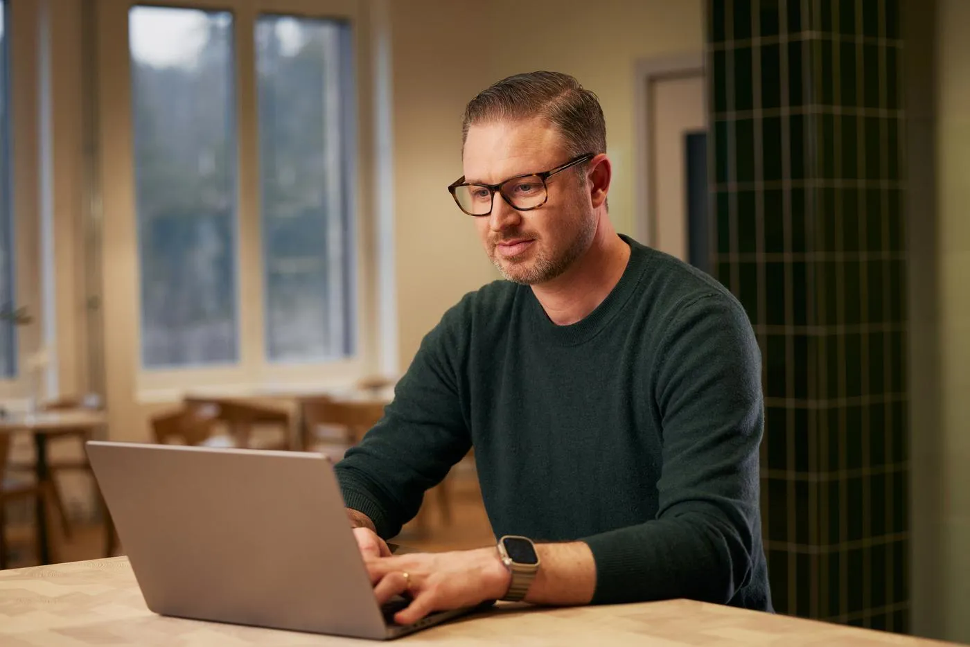 Man working on laptop smiling closeup