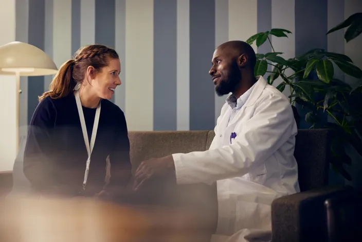 A Social worker and a doctor are talking in hospital