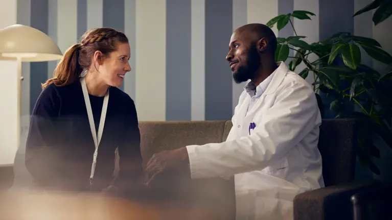 A Social worker and a doctor are talking in hospital