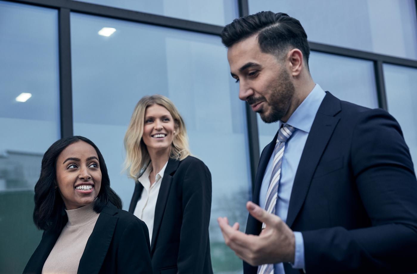 Business people walking, talking and smiling