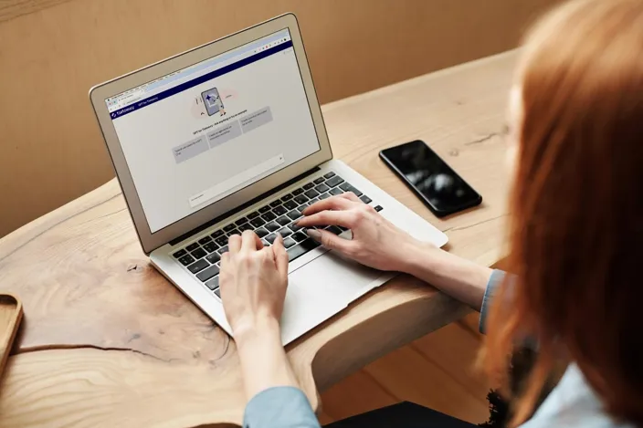 A woman using Tietoevry Chat GPT on her laptop