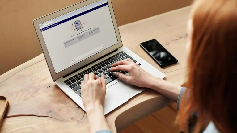 A woman using Tietoevry Chat GPT on her laptop