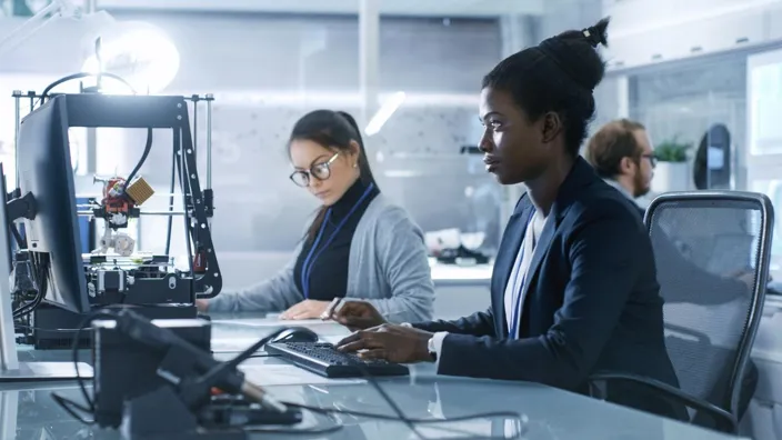 Female Scientist Working on a Computer with Her Colleagues at Research Center