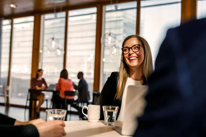 Woman in meeting smiling