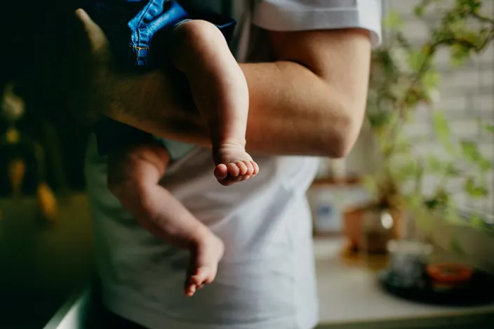 A close-up of a father holding his baby