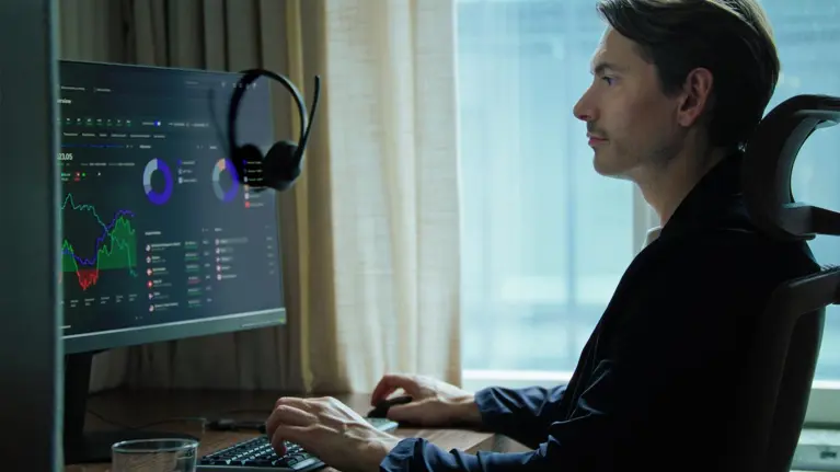 A man using Tietoevry Banking software on his desktop computer