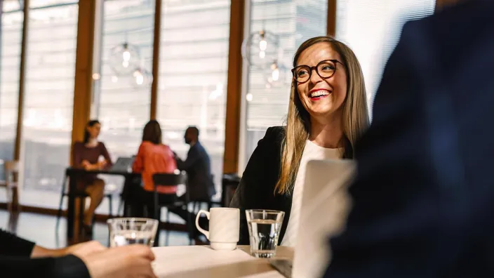 Woman in meeting smiling