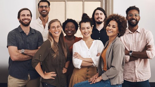 Group of coworkers at the office posing for a camera