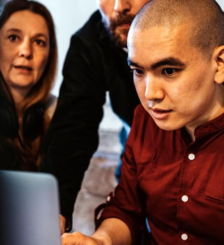 coworkers working on laptop in the office