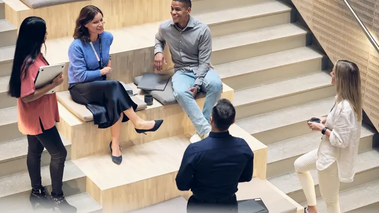 Group of people sitting on stairs at the new tietoevery office building