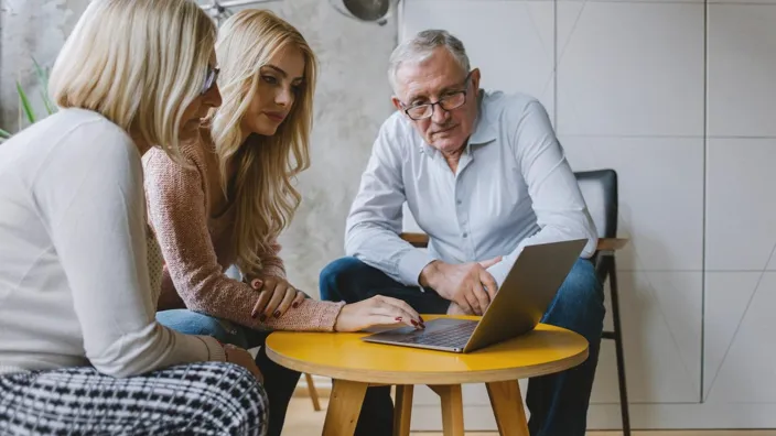 Grandparents Looking At Laptop
Young woman showing to senior couple something on a laptop