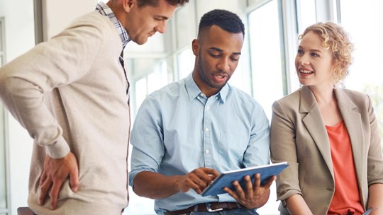 Three businesspeople working together as a team