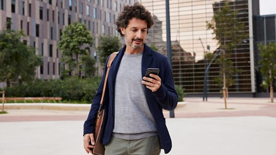 Man walking in the street using mobile phone