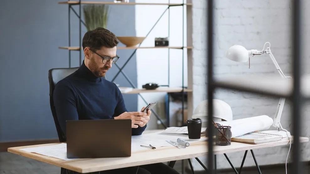 businessman using mobile phone apps, texting message, browsing internet, looking at smartphone