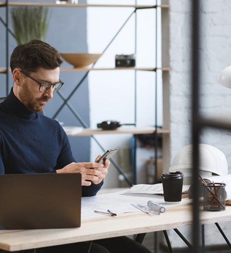 businessman using mobile phone apps, texting message, browsing internet, looking at smartphone