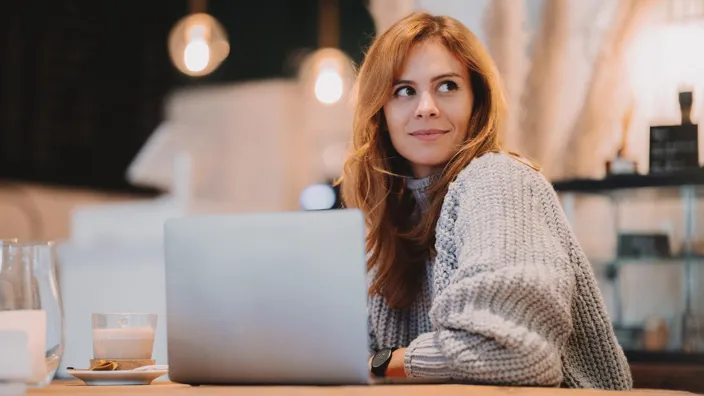 Woman working with her laptop at a cafe