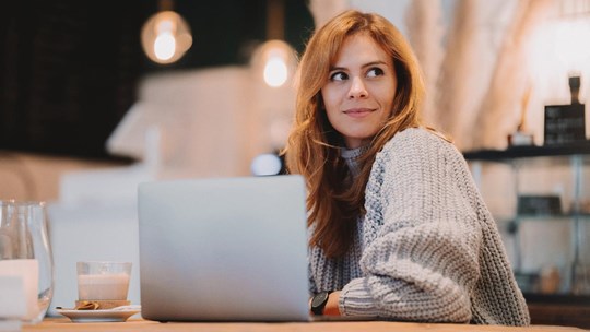 Woman working with her laptop at a cafe