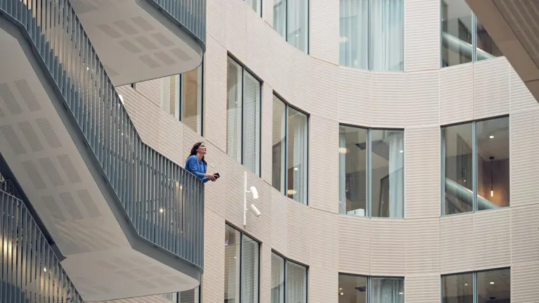 Woman smiling on the stairs in Tietoevry office