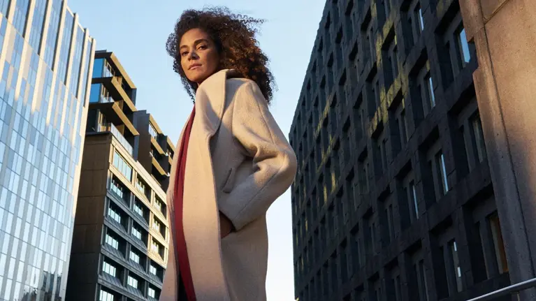Young woman hero portrait in city urban environment